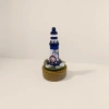Blue and white striped lighthouse model, wooden base, nautical theme decoration, including rudder, shell and fishing net Specification image